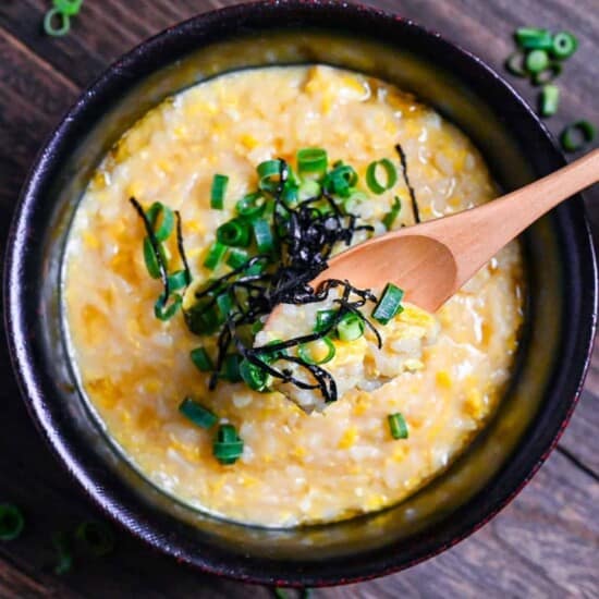 A warm bowl of Japanese-style rice porridge with egg and scallions